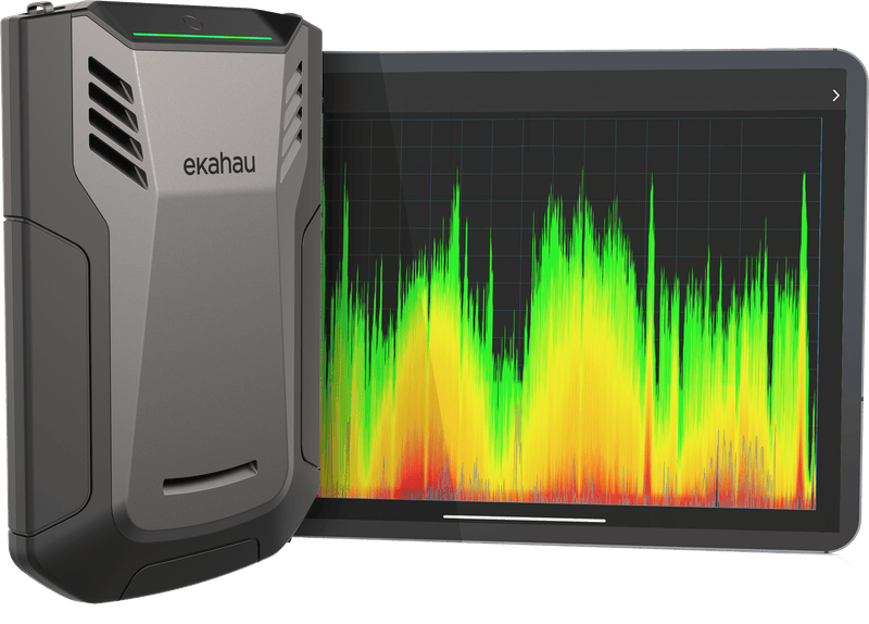 An Ekahau Sidekick beside a tablet showing a live radio frequency spectrum trace