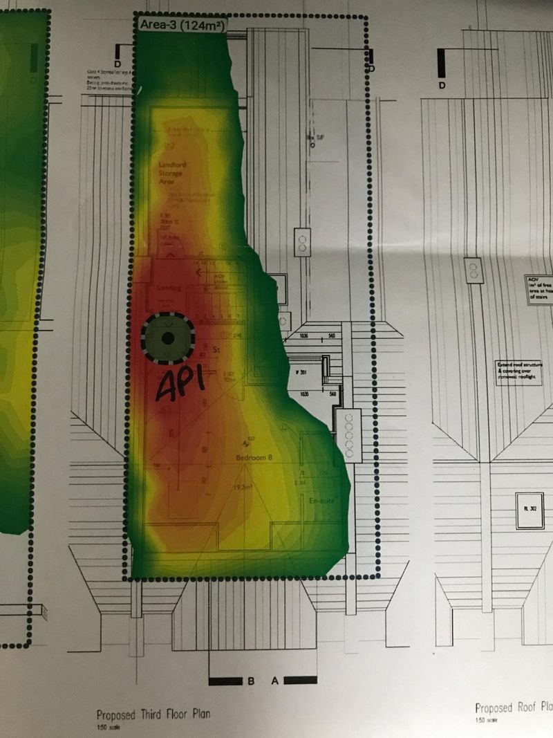 A predicted coverage heatmap over a proposed third floor plan showing a landlord storage area, landing and bedroom, with one access point position marked AP1